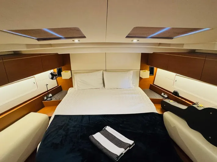 Flight Risk Yacht Photos Pics Luxurious cabin interior of 2020 Beneteau Oceanis 51.1 yacht with cozy bedding.