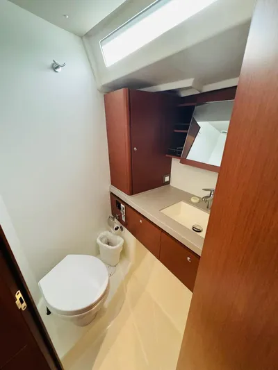 Flight Risk Yacht Photos Pics 2020 Beneteau Oceanis 51.1 yacht bathroom with modern fixtures and wooden cabinetry.