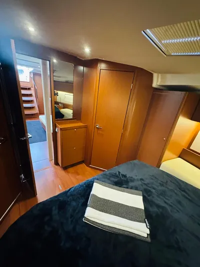 Flight Risk Yacht Photos Pics Luxurious interior of 2020 Beneteau Oceanis 51.1 yacht with cozy cabin and wooden finishes.