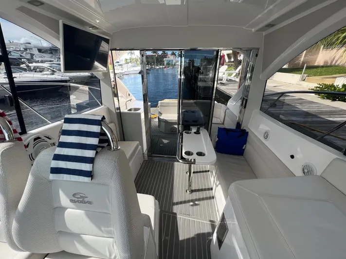 Romaniac Yacht Photos Pics Interior of 2021 Evolve 400HT yacht with modern seating and waterfront view.