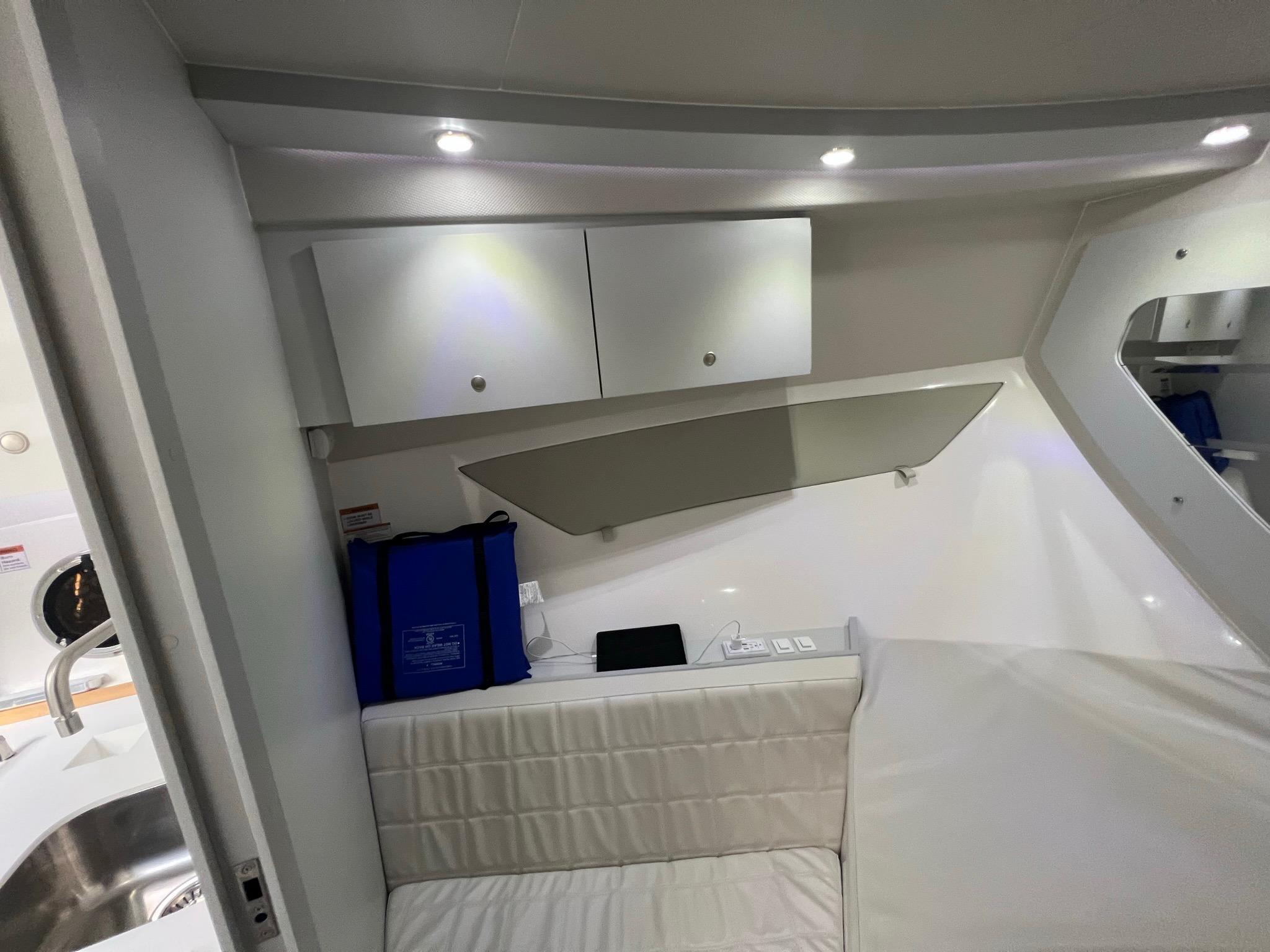 Interior of 2021 Evolve 400HT boat with modern seating and storage cabinets.
