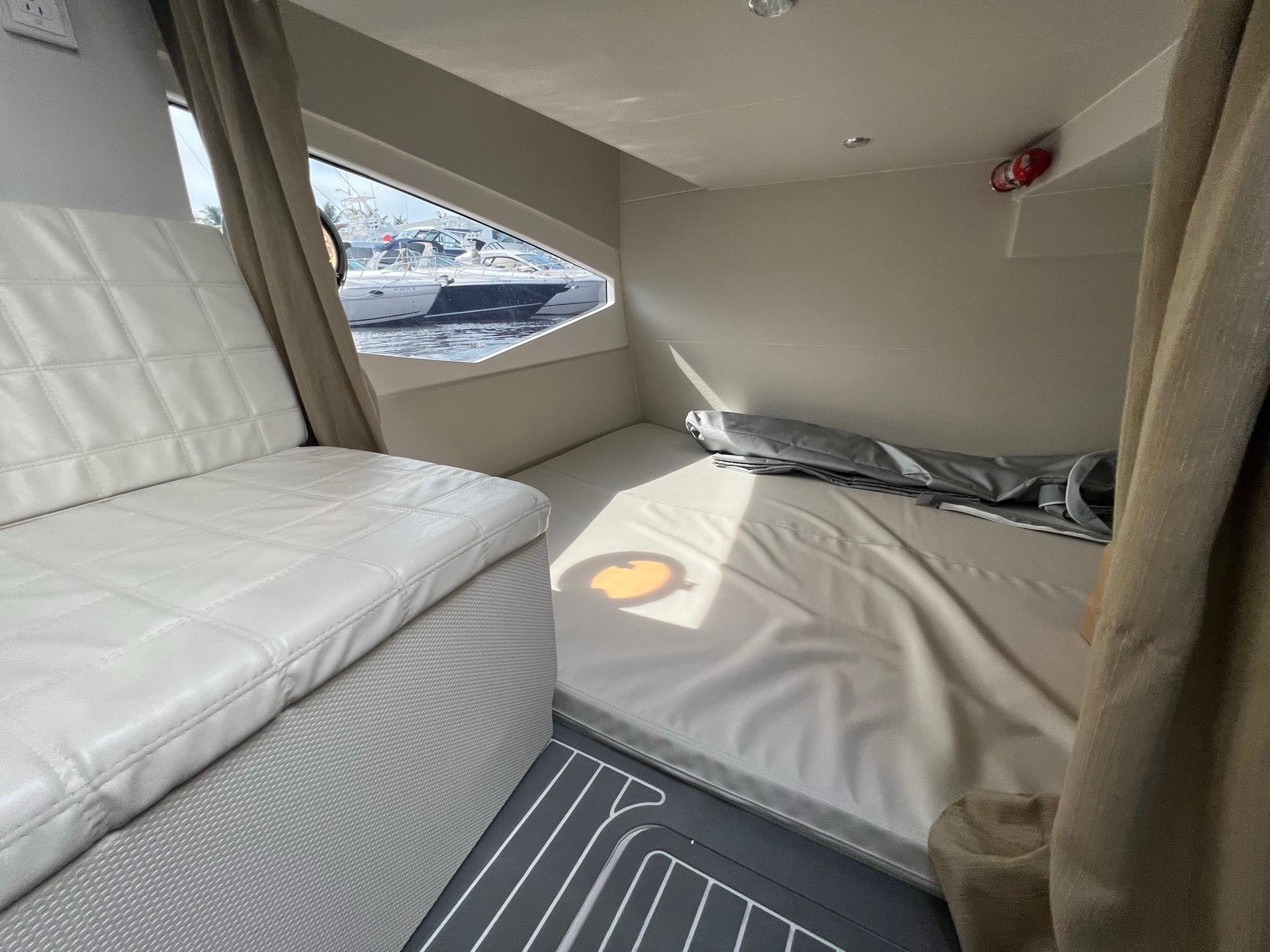 2021 Evolve 400HT cabin interior with seating and bed, featuring modern design and natural light.