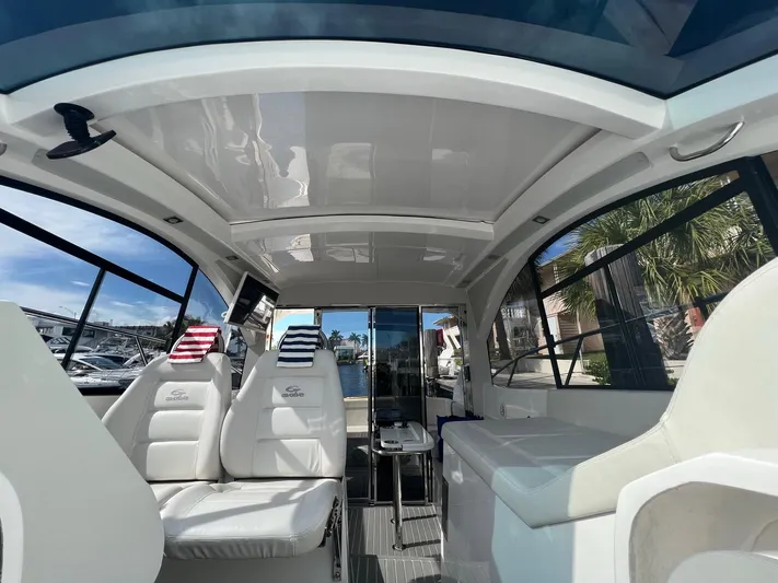 Romaniac Yacht Photos Pics Interior of 2021 Evolve 400HT yacht with luxurious seating and panoramic windows.
