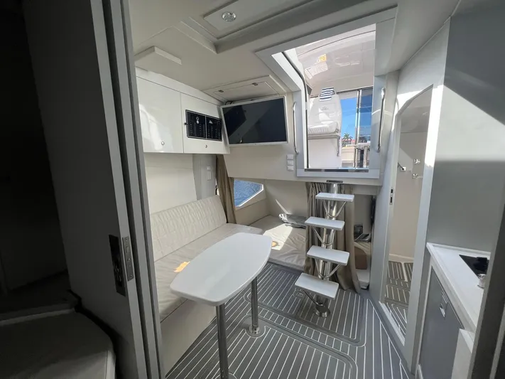 Romaniac Yacht Photos Pics Interior of 2021 Evolve 400HT yacht with modern seating and staircase.