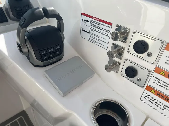 Romaniac Yacht Photos Pics Control panel of 2021 Evolve 400HT boat with throttle and warning labels.