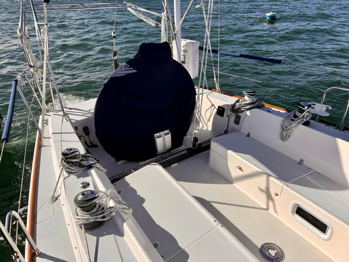 Airwaves Yacht Photos Pics 2006 J Boats J/124 sailboat cockpit with winches and covered wheel, on calm water.