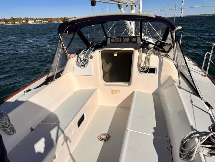 Airwaves Yacht Photos Pics 2006 J Boats J/124 sailboat cockpit with ropes and canopy on open water.