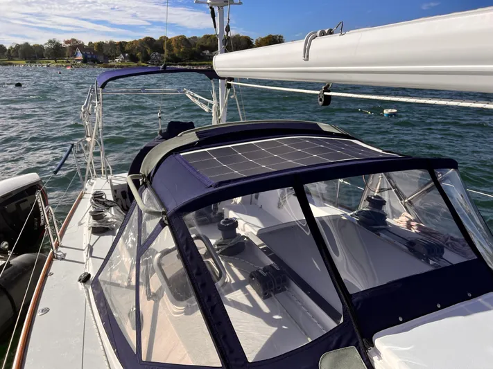 Airwaves Yacht Photos Pics 2006 J Boats J/124 sailboat with solar panel, docked on a sunny day.