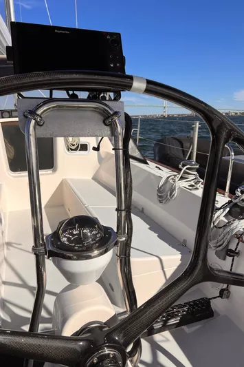 Airwaves Yacht Photos Pics 2006 J Boats J/124 sailboat cockpit with steering wheel and navigation equipment.