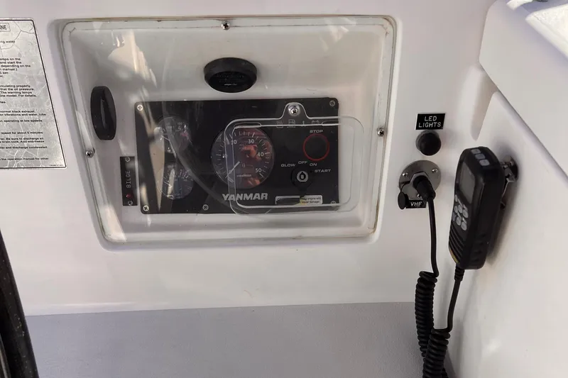 Airwaves Yacht Photos Pics Control panel of a 2006 J Boats J/124 with Yanmar engine display and radio.
