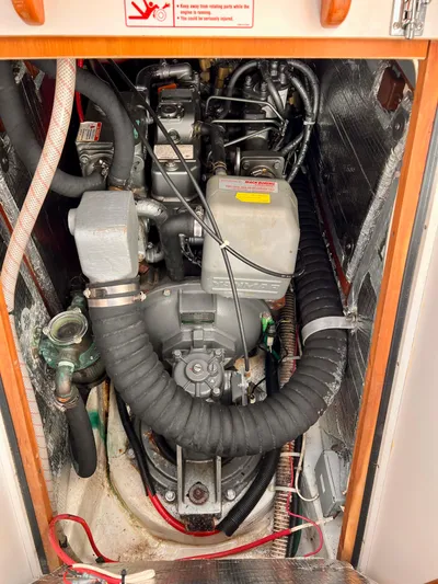 Airwaves Yacht Photos Pics Engine compartment of a 2006 J Boats J/124 sailboat, showcasing mechanical components and wiring.