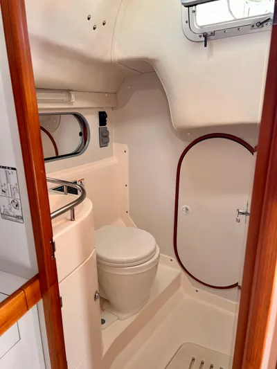 Airwaves Yacht Photos Pics 2006 J Boats J/124 yacht bathroom with compact design and porthole window.