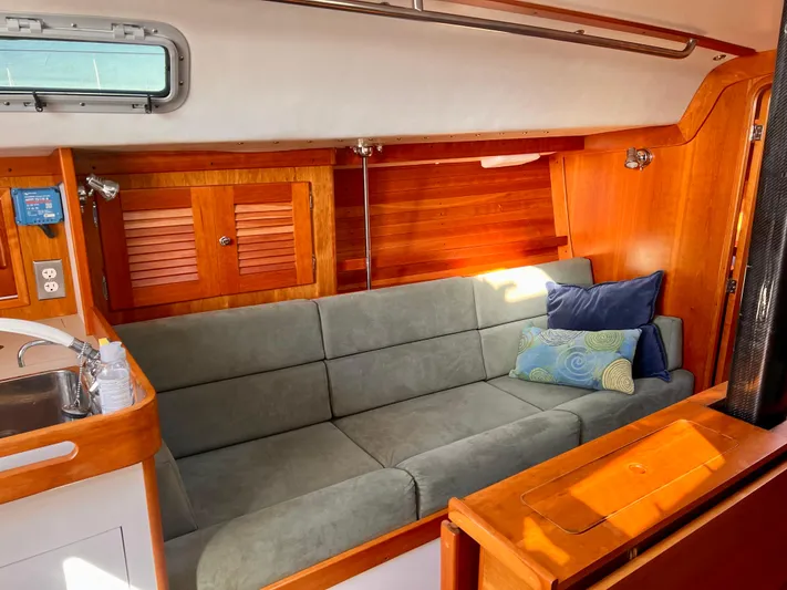 Airwaves Yacht Photos Pics Interior of 2006 J Boats J/124 sailboat with cozy seating and wooden cabinetry.