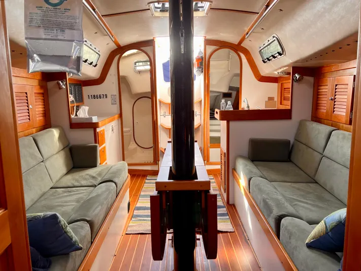 Airwaves Yacht Photos Pics Interior of 2006 J Boats J/124 sailboat with cozy seating and wooden accents.