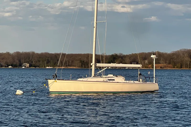 Airwaves Yacht Photos Pics 2006 J Boats J/124 sailboat anchored on calm water with scenic background.
