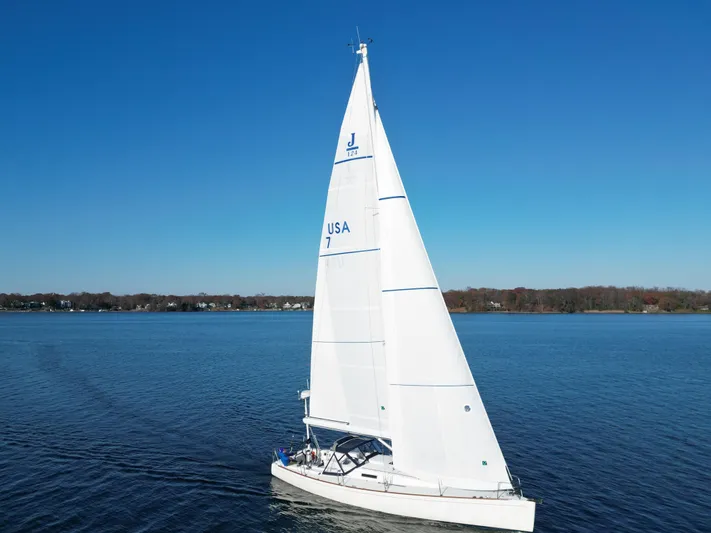 Airwaves Yacht Photos Pics 2006 J Boats J/124 sailing on calm blue waters under clear skies.