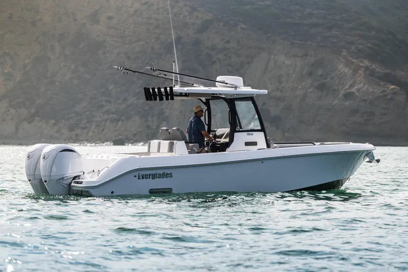 Shark Bait Yacht Photos Pics 2025 Everglades 285 Center Console boat on water, side view with scenic background.