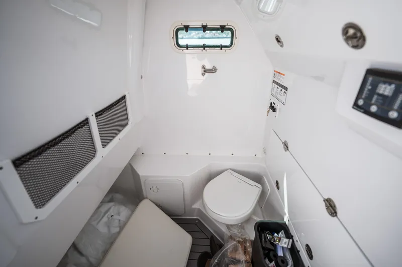 Shark Bait Yacht Photos Pics Interior of 2025 Everglades 285 Center Console boat, featuring a compact marine toilet.