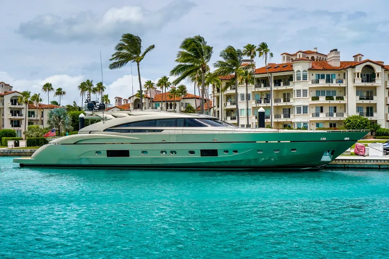 Diamond Yacht Photos Pics Luxury yacht AB 116 (2012) docked near waterfront apartments, turquoise water, palm trees.