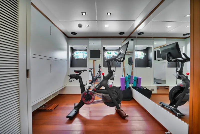 Diamond Yacht Photos Pics Home gym with exercise bike, mirrors, and fitness equipment on wooden floor. AB 116, 2012 model.