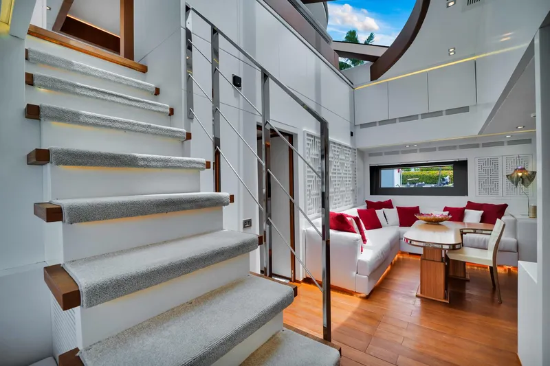 Diamond Yacht Photos Pics Luxurious interior of 2012 AB 116 yacht with modern staircase and cozy seating area.