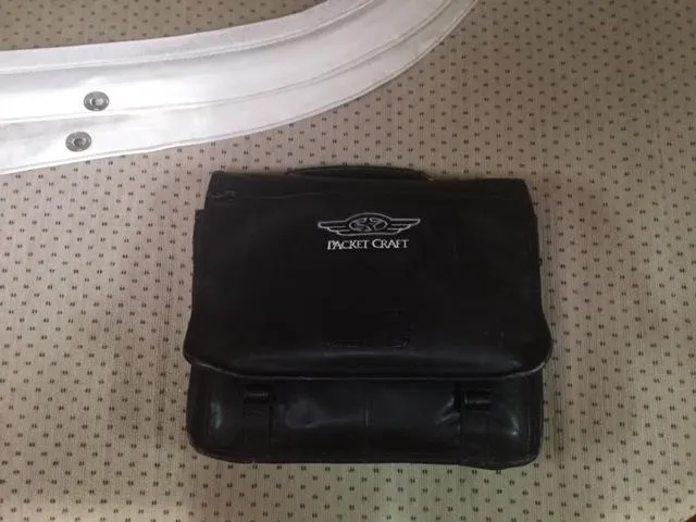 Navigator Yacht Photos Pics Black Packet Craft bag on dotted background.