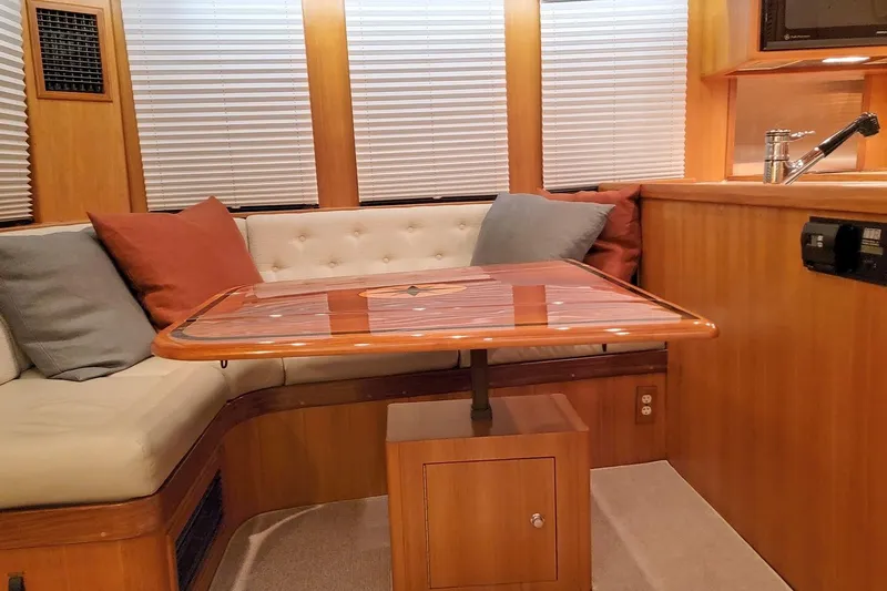 Carolina Yacht Photos Pics Interior of 2001 Nordhavn 46 yacht with cozy seating and wooden table.
