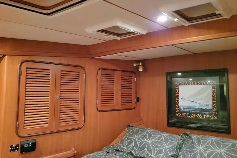 Carolina Yacht Photos Pics Interior of 2001 Nordhavn 46 yacht with wood paneling and framed maritime poster.