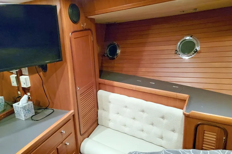 Carolina Yacht Photos Pics Cozy interior of 2001 Nordhavn 46 yacht with wood paneling and portholes.