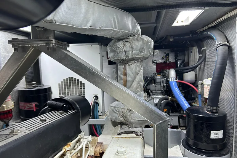 Carolina Yacht Photos Pics Engine room of a 2001 Nordhavn 46 yacht, showcasing mechanical components and piping.