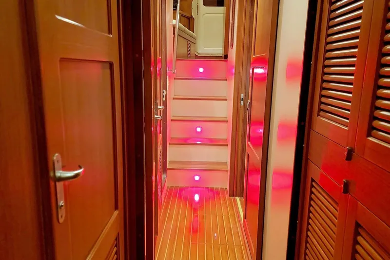 Carolina Yacht Photos Pics Interior of 2001 Nordhavn 46 yacht with illuminated wooden hallway and stairs.