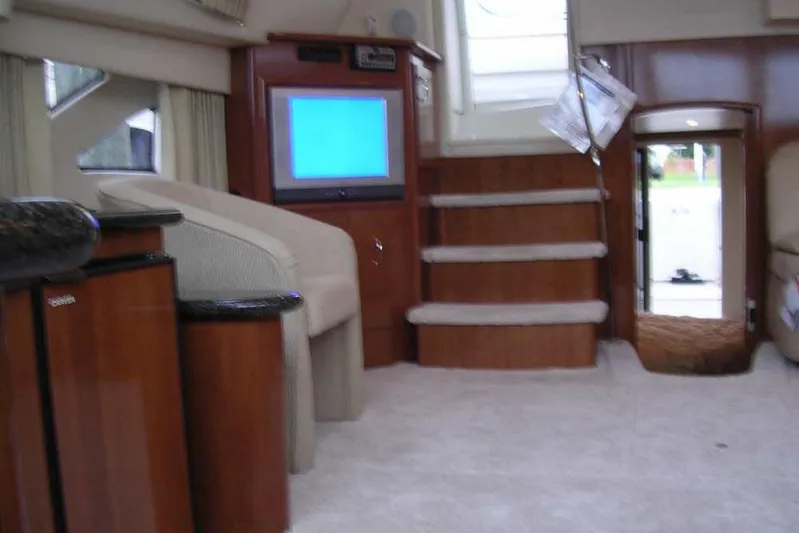  Yacht Photos Pics Interior of 2006 Carver 41 Cockpit Motor Yacht with TV, stairs, and seating area.