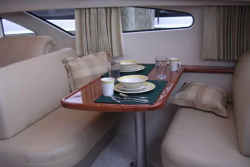  Yacht Photos Pics Interior dining area of 2006 Carver 41 Cockpit Motor Yacht with table setting.