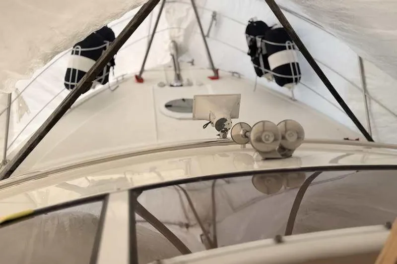  Yacht Photos Pics 2006 Carver 41 Cockpit Motor Yacht under protective cover, showcasing deck and equipment.