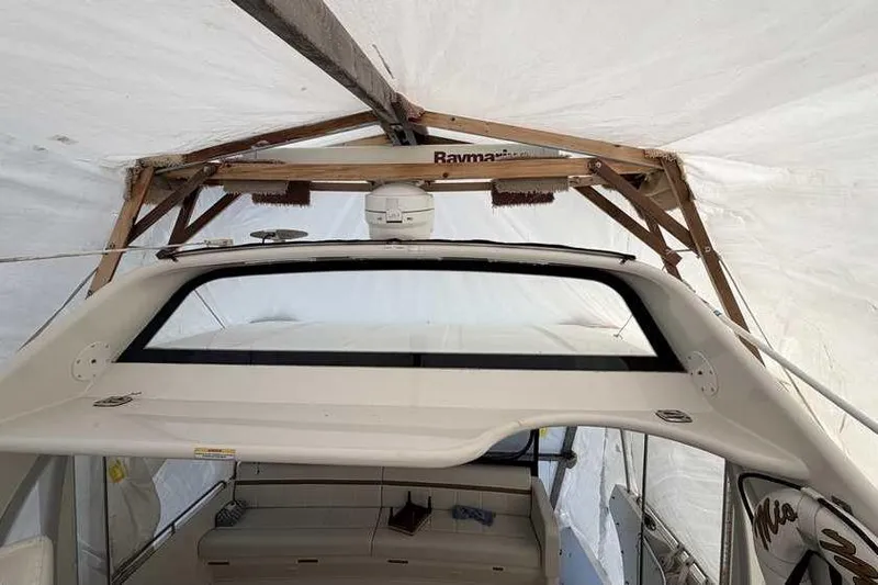  Yacht Photos Pics 2006 Carver 41 Cockpit Motor Yacht under protective cover, showcasing cockpit and seating area.