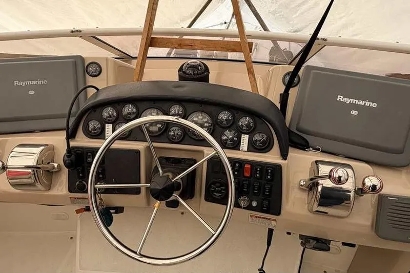  Yacht Photos Pics 2006 Carver 41 Cockpit Motor Yacht helm with Raymarine navigation systems and steering wheel.