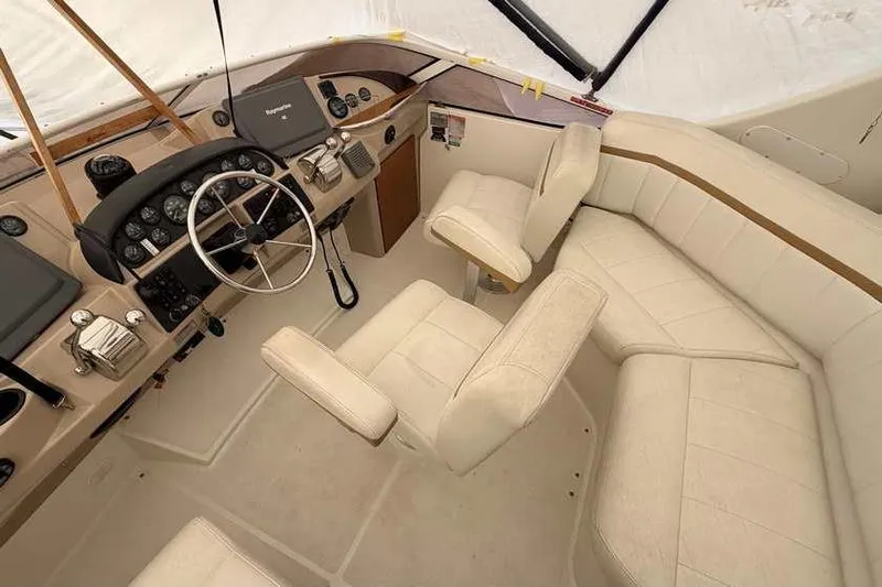  Yacht Photos Pics Interior of 2006 Carver 41 Cockpit Motor Yacht with beige seating and helm controls.