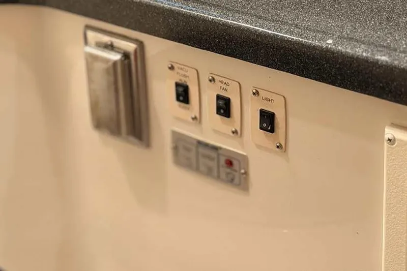  Yacht Photos Pics Control panel on 2006 Carver 41 Cockpit Motor Yacht with switches for vacu-flush, fan, and light.