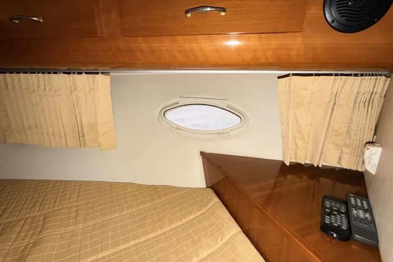  Yacht Photos Pics Interior of 2006 Carver 41 Cockpit Motor Yacht with wood cabinetry and porthole window.