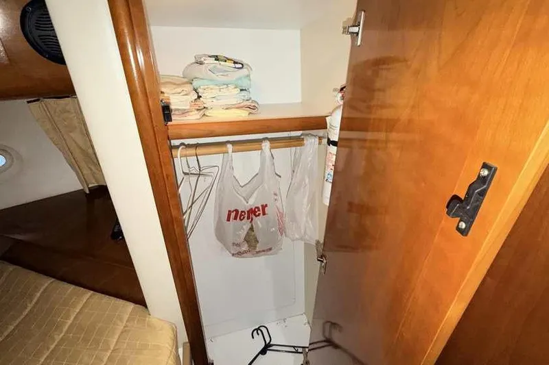  Yacht Photos Pics Closet interior of 2006 Carver 41 Cockpit Motor Yacht with shelves and hangers.