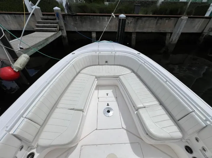 Blu Yacht Photos Pics 2015 Intrepid 327 boat with white seating, docked at marina.