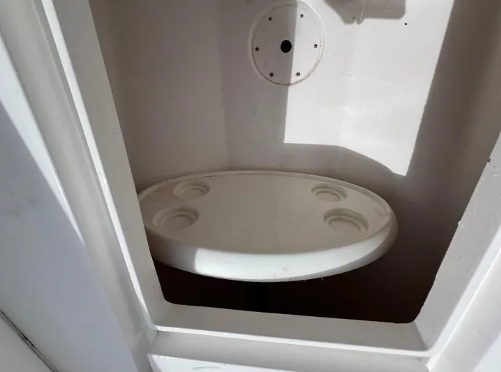 Blu Yacht Photos Pics Storage compartment with cup holders in a 2015 Intrepid 327 boat.