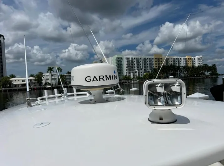 Blu Yacht Photos Pics 2015 Intrepid 327 boat with Garmin radar and spotlight, docked near waterfront buildings.