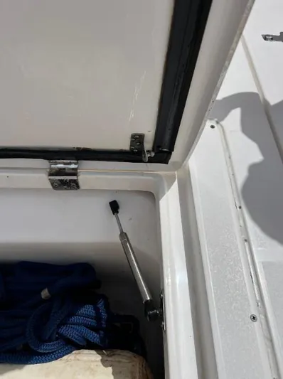 Blu Yacht Photos Pics Open storage compartment on 2015 Intrepid 327 boat with blue rope inside.