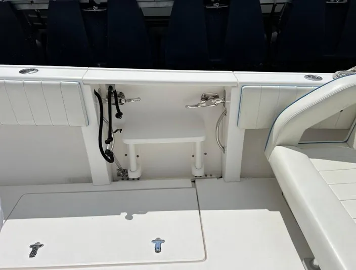 Blu Yacht Photos Pics 2015 Intrepid 327 boat interior with white seating and storage compartments.