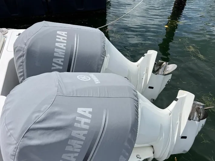 Blu Yacht Photos Pics Twin Yamaha outboard motors on a 2015 Intrepid 327 boat, docked in water.