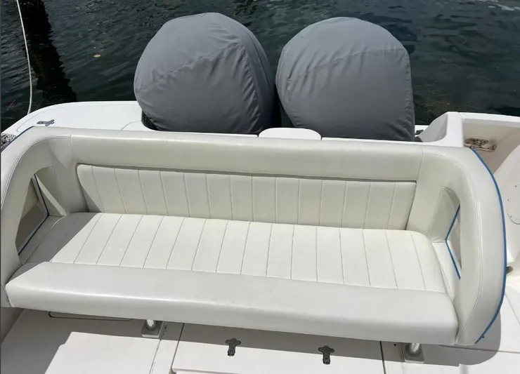 Blu Yacht Photos Pics White leather seating on a 2015 Intrepid 327 boat, with covered engines in the background.