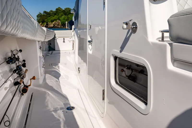  Yacht Photos Pics 2024 HCB 39 Speciale boat deck with fishing rods and storage compartments.