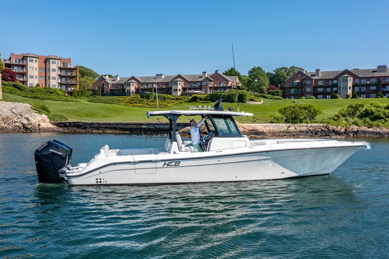  Yacht Photos Pics 2024 HCB 39 Speciale boat cruising near waterfront homes.