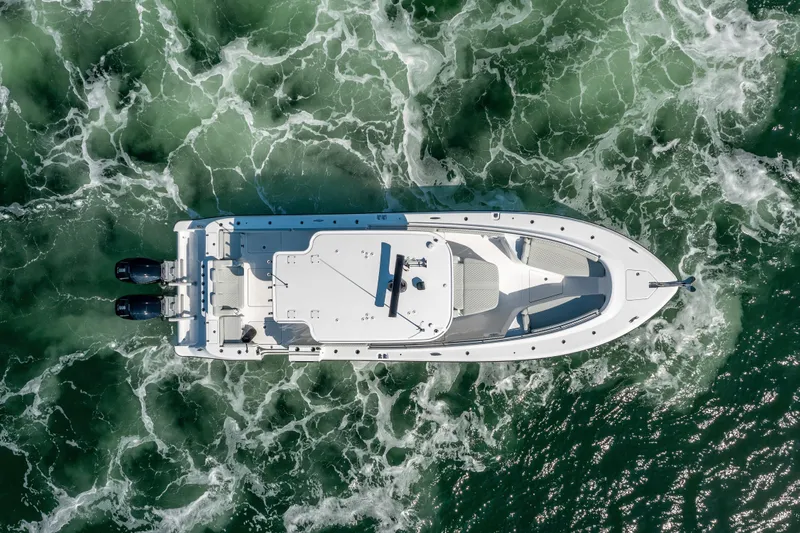  Yacht Photos Pics Aerial view of 2024 HCB 39 Speciale boat cruising through green ocean waters.
